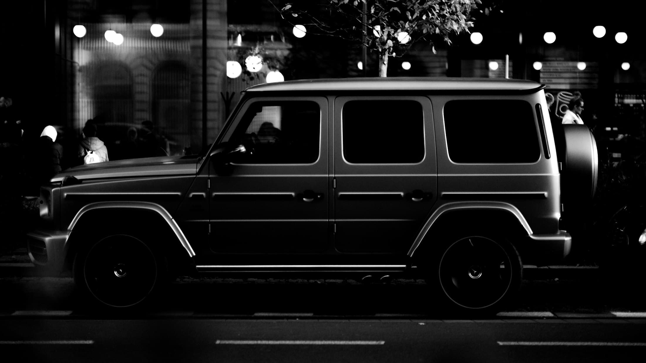 Black luxury SUV on a Los Angeles street at night